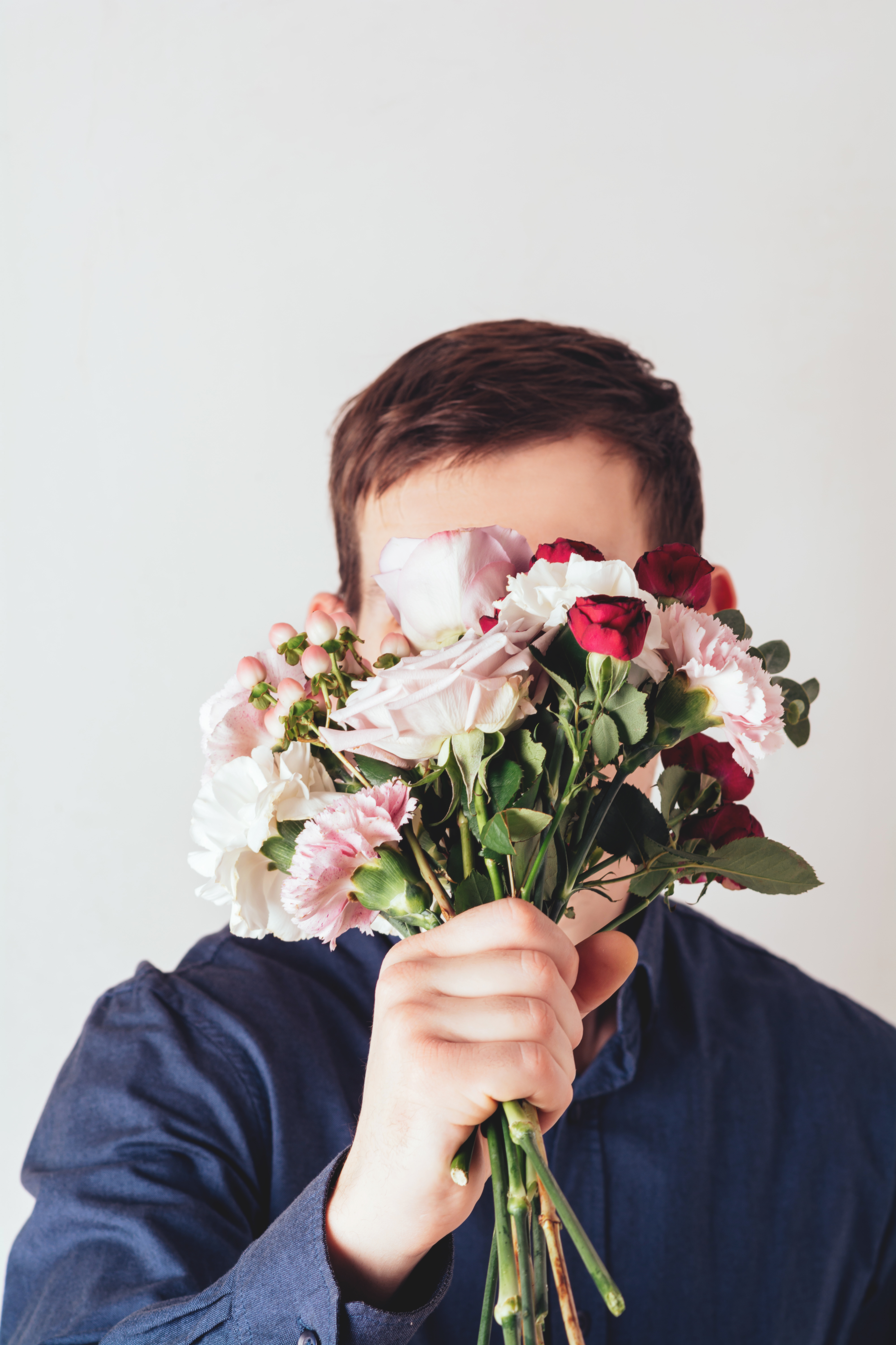 a man holding a bouquet of flowers in front of his 2022 10 27 19 32 22 utc